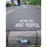 Photo of stencil of a junk boat on an inner city roadside gutter