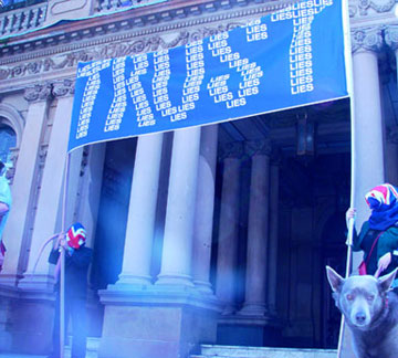 Liberal party rats holding the TRUST the Lies Banner a the End teh Lies Rally